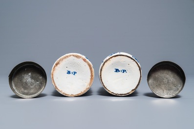 A pair of Dutch Delft blue and white drug jars with brass lids, 18th C.