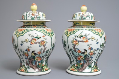 A pair of Chinese famille verte vases and covers with birds and flowers, 19th C.