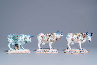 A pair of polychrome Dutch Delft models of cows and one with a milker, 19th C.