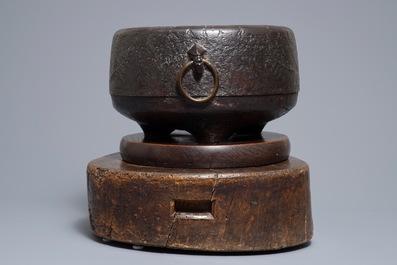 A Japanese relief-decorated cast iron furogama on wooden stand, Edo/Meiji, 18/19th C.