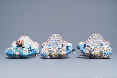 A pair of polychrome Dutch Delft models of cows and one with a milker, 19th C.