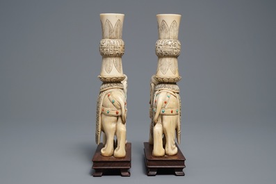 A pair of Chinese coral- and turquoise inlaid ivory elephant candlesticks, 19th C.