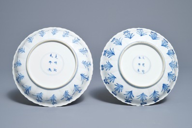 A pair of Chinese blue and white 'Mongolian hunting scene' plates, Chenghua marks, Kangxi