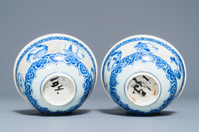 A pair of Chinese blue and white reticulated bowls with landscape panels, Transitional period