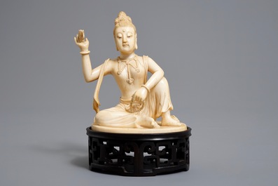A Chinese carved ivory figure of Guanyin on wooden stand with original box, Republic, early 20th C.