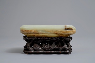 A Chinese celadon and russet jade box and cover on wooden stand, Ming/Qing