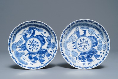 A pair of Chinese blue and white French market cups and saucers with texts, Kangxi