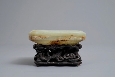 A Chinese celadon and russet jade box and cover on wooden stand, Ming/Qing