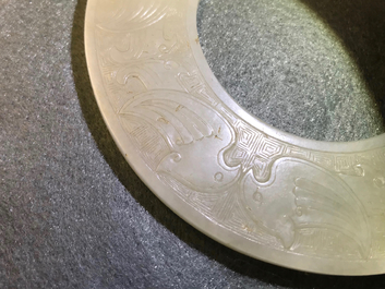 A Chinese pale celadon jade bi disc, Ming or earlier