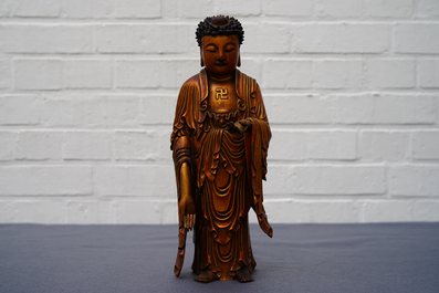 A Chinese carved gilt wood figure of Buddha standing, 18/19th C.