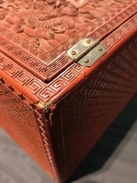 A Chinese cinnabar 'dragons and phoenixes' lacquer cabinet, 19th C.