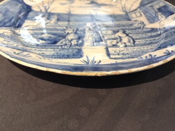 A Dutch Delft blue and white plate with peasants from the 'Zodiac' series, first quarter 18th C.