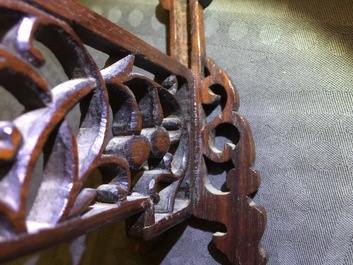 A small Chinese jade plaque mounted in a carved wood table screen, 19/20th C.