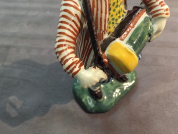 A polychrome Dutch Delft model of a hurdy-gurdy player, 18th C.