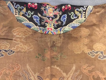 A Chinese brown ground eight-dragon embroidered silk robe, Qianlong