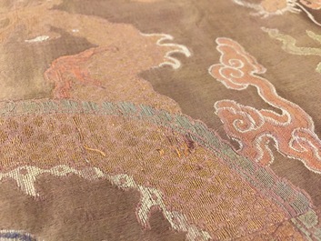 A Chinese brown ground eight-dragon embroidered silk robe, Qianlong