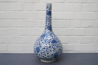 A Chinese blue and white 'lotus scroll' bottle vase, 18/19th C.