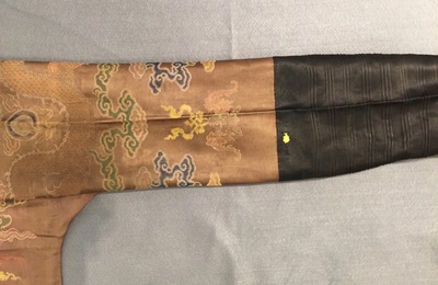 A Chinese brown ground eight-dragon embroidered silk robe, Qianlong