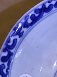 A pair of Chinese blue and white French market cups and saucers with texts, Kangxi