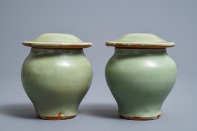 A pair of Chinese Longquan celadon vases and covers, Ming