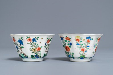 A pair of lobed Chinese famille verte cups and saucers, Kangxi