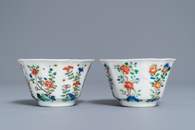 A pair of lobed Chinese famille verte cups and saucers, Kangxi