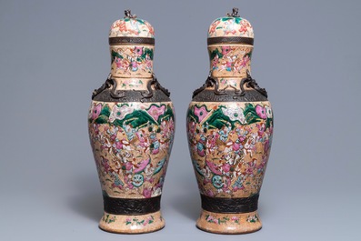 A pair of Chinese Nanking famille rose vases and covers, 19th C.