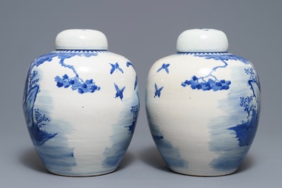 A pair of Chinese blue and white jars and covers with figures in a garden, Kangxi mark, 19th C.