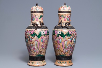 A pair of Chinese Nanking famille rose vases and covers, 19th C.