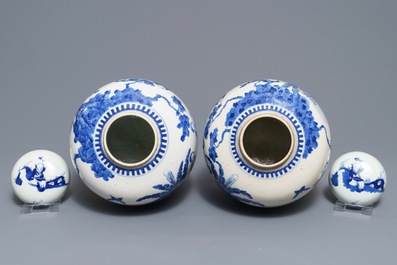 A pair of Chinese blue and white jars and covers with figures in a garden, Kangxi mark, 19th C.