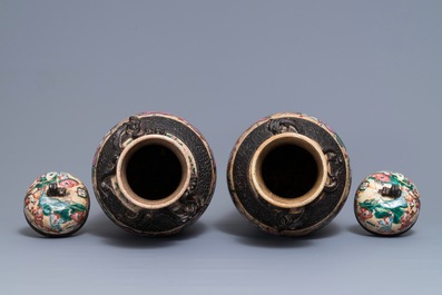 A pair of Chinese Nanking famille rose vases and covers, 19th C.