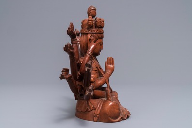 A Chinese huangyang wood figure of the 12-armed Guanyin, Republic, 20th C.