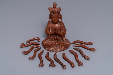 A Chinese huangyang wood figure of the 12-armed Guanyin, Republic, 20th C.