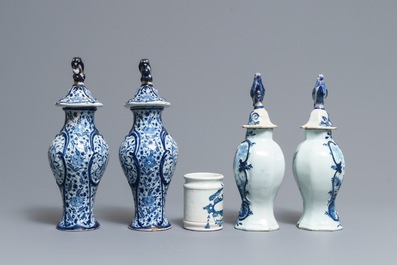 Two pairs of Dutch Delft blue and white covered vases and a drug jar, 18th C.