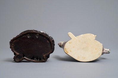 A Chinese famille rose semi-erotic teapot on wooden stand, Republic, 20th C.