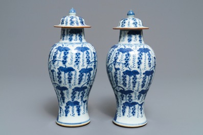 A pair of Chinese blue and white vases and covers with grapes, Kangxi