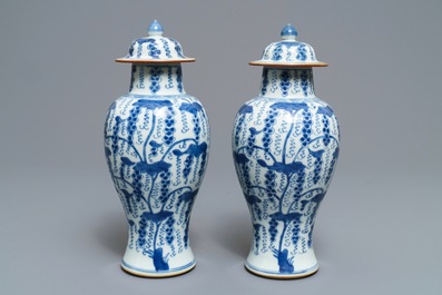 A pair of Chinese blue and white vases and covers with grapes, Kangxi