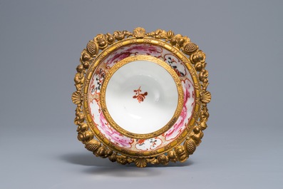 A Chinese famille rose 'mandarin' cup and saucer in gilt metal mount, Qianlong and 19th C.