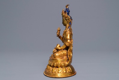 A Tibetan coral- and turquoise-inlaid gilt copper alloy figure of Tara, 19/20th C.