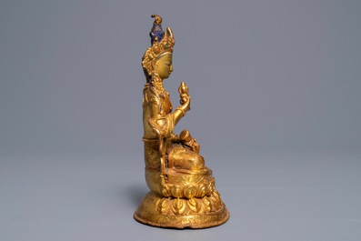 A Tibetan coral- and turquoise-inlaid gilt copper alloy figure of Tara, 19/20th C.