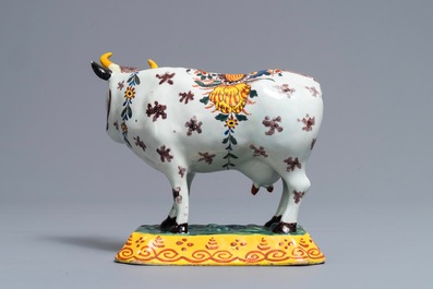 A polychrome Dutch Delft cow on base with frogs, 18th C.