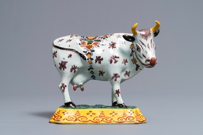 A polychrome Dutch Delft cow on base with frogs, 18th C.