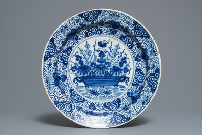 Two Dutch Delft blue and white chargers, an oval dish and a vase, 18th C.