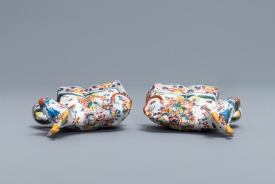 A pair of polychrome Dutch Delft models of recumbent cows, 18th C.