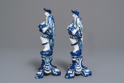 A pair of Dutch Delft blue and white models hurdy-gurdy players, 18th C.