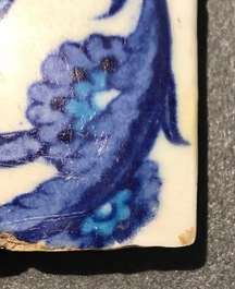 A bichrome Iznik border tile with saz leaves, cloud bands and a rosette, Turkey, 2nd quarter 16th C.