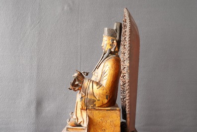 A large Chinese gilt-laquered and inlaid bronze figure of Zhenwu on gilt wooden base, Ming