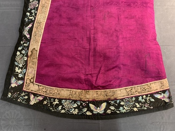 A Chinese informal Manchu embroidered silk pink-ground women's robe, 19th C.