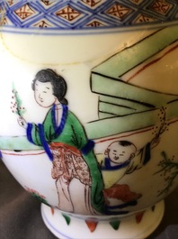 A Chinese wucai baluster vase with figures in a garden, Transitional period