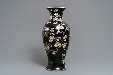 A Chinese famille noire 'magpie and prunus' vase, Kangxi